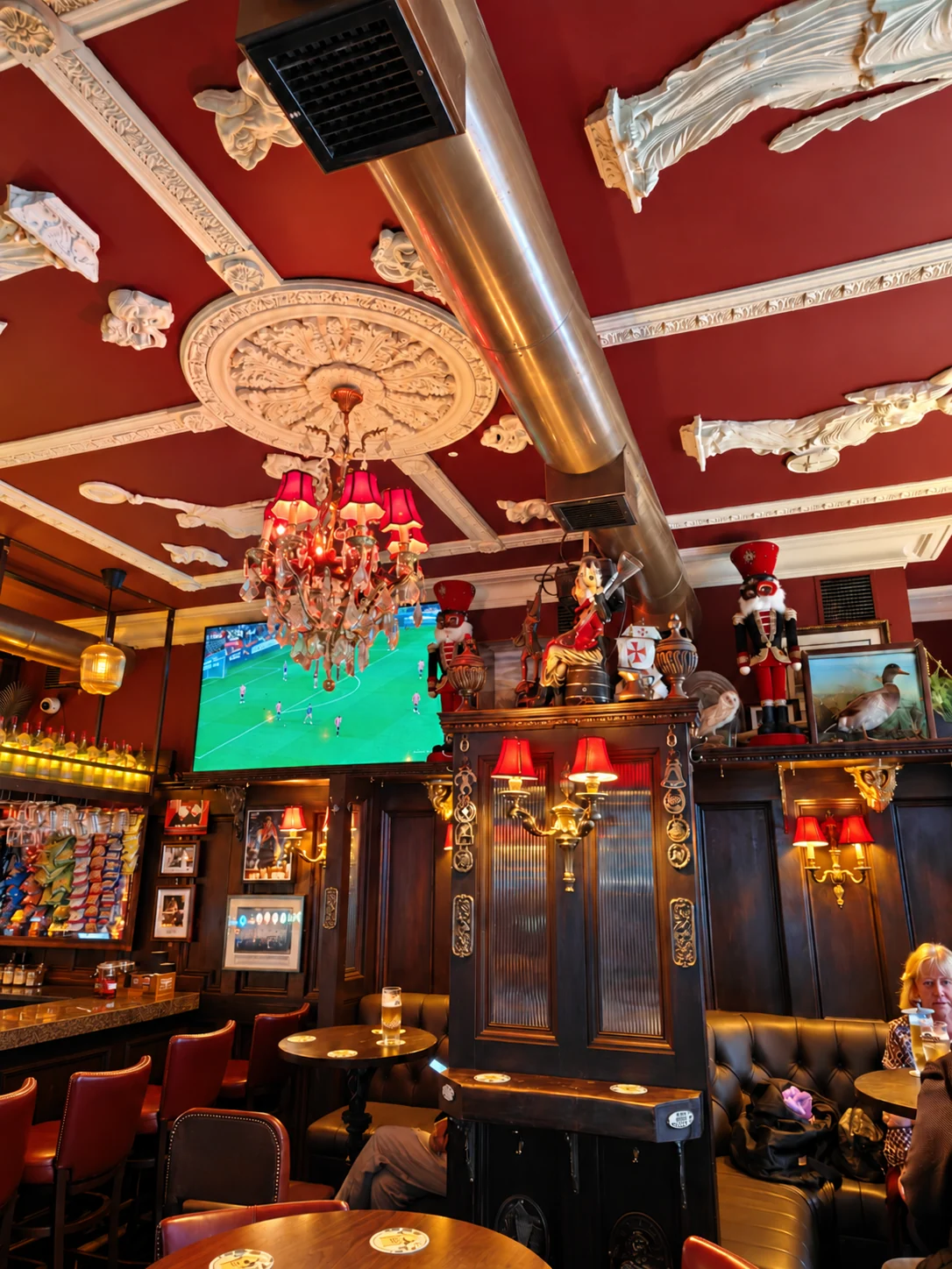 Ornate ceiling, chandelier and traditional seating in the main bar at The Flowing Tide on Abbey Street