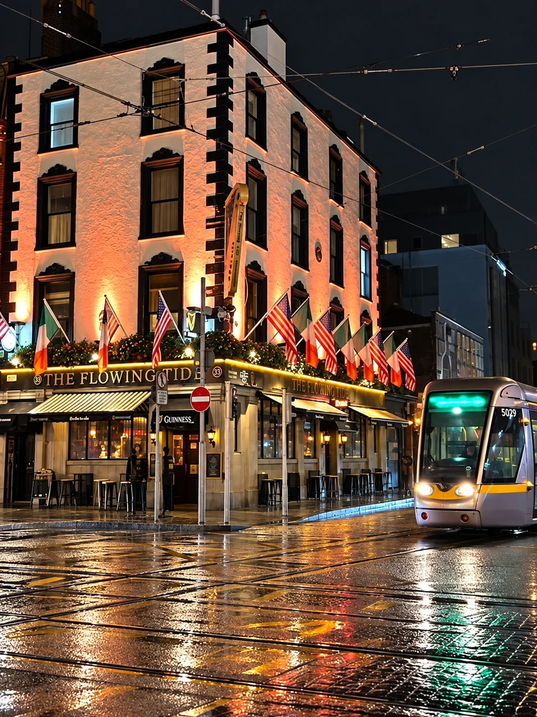 The Flowing Tide on Abbey Street at night with the Luas passing outside